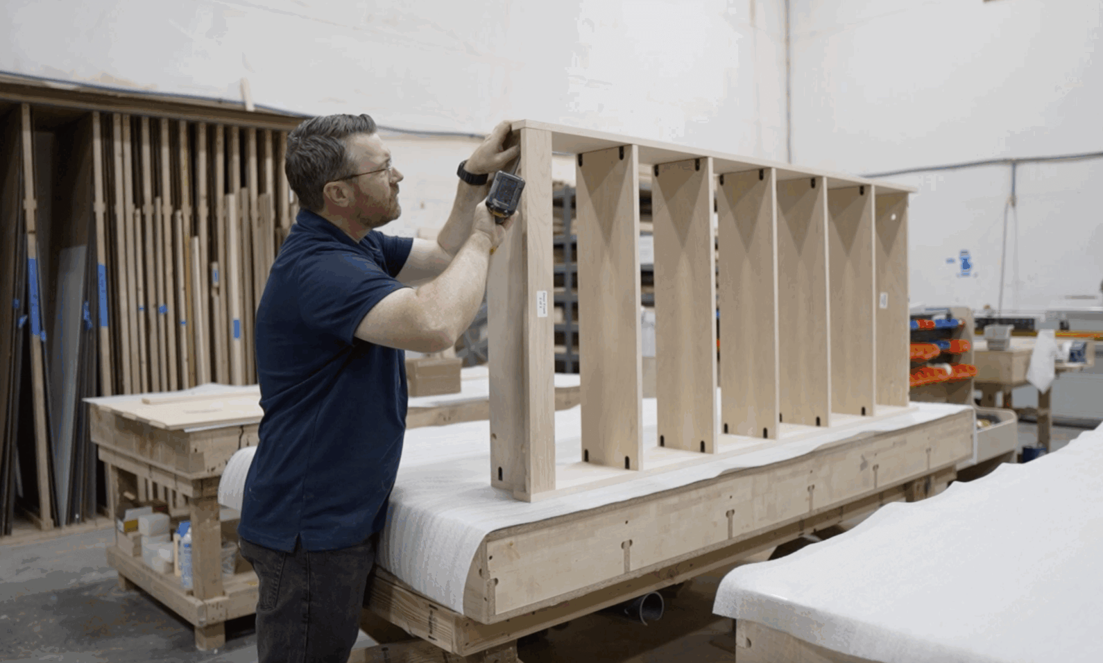 Travis from Hidden Door Store builds the shelves of the DIY Hidden Door (out-swing) in an installation video.